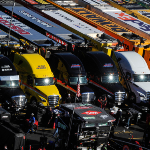 The sun is reflected in the windshields of several Monster Energy NASCAR Cup Series haulers during the STP 500 at Martinsville Speedway.
