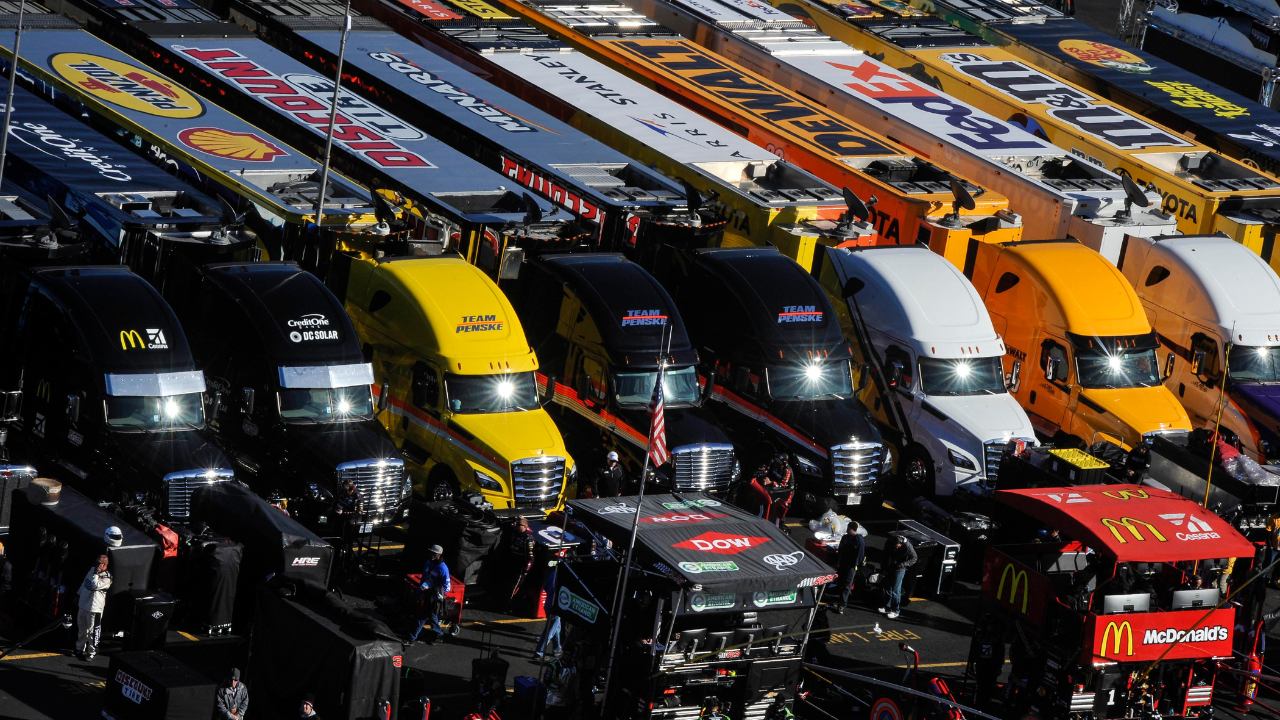 The sun is reflected in the windshields of several Monster Energy NASCAR Cup Series haulers during the STP 500 at Martinsville Speedway.