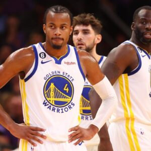 Golden State Warriors guard Moses Moody (4), forward Jonathan Kuminga (00) and forward Draymond Green (23) against the Phoenix Suns at Footprint Center.