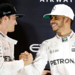 Mercedes Formula One driver Nico Rosberg (L) of Germany shakes hands with Lewis Hamilton of Britain