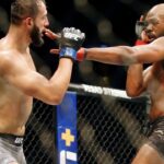 Jon Jones (red gloves) fights Dominick Reyes (blue gloves) during UFC 247 at Toyota Center.