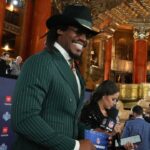 Former NFL quarterback Cam Newton stands on the red carpet ahead of the 2024 NFL Draft at Detroit’s Fox Theatre.