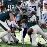 Nov 10, 2024; Arlington, Texas, USA; Dallas Cowboys running back Ezekiel Elliott (15) fumbles the ball after bring hit by Philadelphia Eagles cornerback Cooper DeJean (33) in the second quarter at AT&T Stadium.