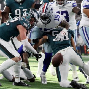 Nov 10, 2024; Arlington, Texas, USA; Dallas Cowboys running back Ezekiel Elliott (15) fumbles the ball after bring hit by Philadelphia Eagles cornerback Cooper DeJean (33) in the second quarter at AT&T Stadium.