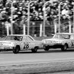 DAYTONA BEACH - FEBRUARY 24: Cars race past the grandstands during the Daytona 500, Daytona Beach, Florida, February 24, 1963. American driver Fred Lorenzen is in car #28, while Ned Jarrett drives #11. Michael Rougier/The LIFE Picture Collection