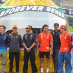 The Formula 1 drivers pose in front of a large helmet by Ayrton Senna Forever Senna Sao Paulo