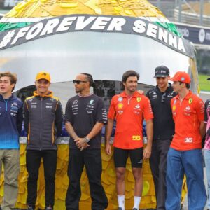 The Formula 1 drivers pose in front of a large helmet by Ayrton Senna Forever Senna Sao Paulo