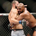 Jon Jones (red gloves) fights Dominick Reyes (blue gloves) during UFC 247 at Toyota Center.