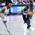 Dallas Mavericks guard Kyrie Irving (11) drives to the basket as Phoenix Suns forward Kevin Durant (35) defends during the fourth quarter at American Airlines Center.