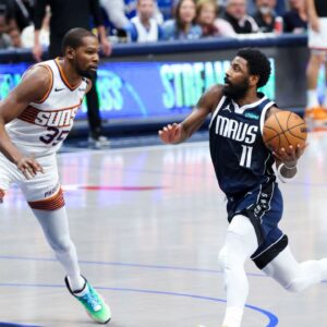 Dallas Mavericks guard Kyrie Irving (11) drives to the basket as Phoenix Suns forward Kevin Durant (35) defends during the fourth quarter at American Airlines Center.
