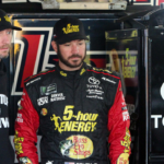 NASCAR Cup Series driver Martin Truex Jr (right) talks with his crew chief Cole Pearn (left) during practice for the Gander Outdoors 400 at Dover International Speedway.