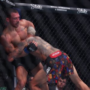 Charles Oliveira (red gloves) fights Michael Chandler (blue gloves) in the lightweight bout during UFC 309 at Madison Square Garden.