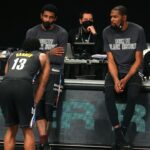 Brooklyn Nets point guard Kyrie Irving (C) and power forward Kevin Durant (R) talk to shooting guard James Harden (13) before checking into the game during the fourth quarter against the Los Angeles Clippers at Barclays Center.