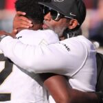 Colorado football coach Deion Sanders hugs his son, Shedeur Sanders, before facing Texas Tech in a Big 12 football game Saturday, Nov. 9, 2024, at Jones AT&T Stadium.