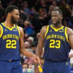Golden State Warriors forwards Andrew Wiggins (22) and Draymond Green (23) talk during overtime against the Los Angeles Lakers at Chase Center