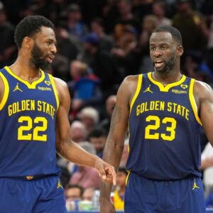 Golden State Warriors forwards Andrew Wiggins (22) and Draymond Green (23) talk during overtime against the Los Angeles Lakers at Chase Center