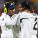 Oct 7, 2023; Tempe, Arizona, USA; Colorado Buffaloes head coach Deion Sanders reacts as he talks to son and quarterback Shedeur Sanders (2) after a penalty against the Arizona State Sun Devils in the second half at Mountain America Stadium.