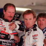 Dale Earnhardt points something out to Rusty Wallace in the garage during practice at Daytona International Speedway on Wednesday, February 16, 2000.