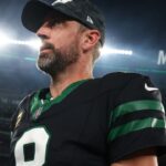 New York Jets quarterback Aaron Rodgers (8) walks off the field after the Jets win over the Houston Texans at MetLife Stadium.