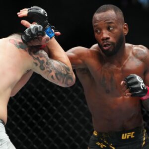 ; Leon Edwards (red gloves) fights Colby Covington (blue gloves) during UFC 296 at T-Mobile Arena.