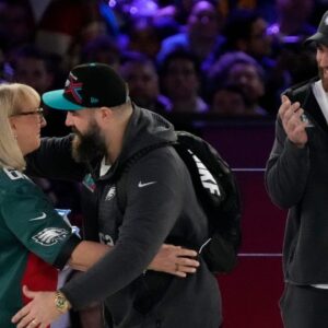 Donna Kelce hugs her son Philadelphia Eagles center Jason Kelce (62) while her other son Kansas City Chiefs tight end Travis Kelce (87) claps at the Footprint Center in downtown Phoenix during the NFL's Super Bowl Opening Night on Feb. 6, 2023. Nfl Super Bowl Lvii Opening Night Kansas City Chiefs