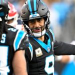 Nov 24, 2024; Charlotte, North Carolina, USA; Carolina Panthers quarterback Bryce Young (9) talks to running back Jonathon Brooks (24) in the fourth quarter at Bank of America Stadium.