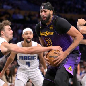 Orlando Magic forward Franz Wagner (22) and center Goga Bitadze (35) defend Los Angeles Lakers forward Anthony Davis (3) in the second half at Crypto.com Arena.