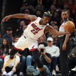 Miami Heat forward Jimmy Butler (22) saves the ball against the Phoenix Suns during the first half at Footprint Center