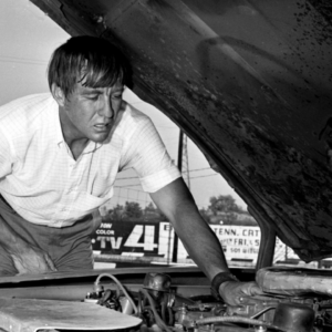 Driver Bobby Isaac makes sure everything is in good working order under the hood of his 1969 Dodge Charger before driving in the NASCAR 400 at Fairgrounds Speedway July 26, 1969. Isaac was second fastest qualifier. Title 1969 Auto Racing