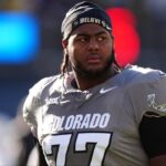 Colorado Buffaloes offensive tackle Jordan Seaton (77) looks on before the game against the Utah Utes at Folsom Field.