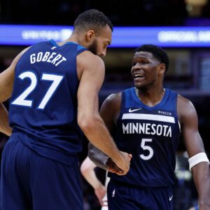 Minnesota Timberwolves center Rudy Gobert (27) reacts with guard Anthony Edwards (5) during the first half of an NBA game against the Chicago Bulls at United Center.