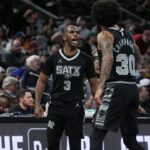 San Antonio Spurs guard Chris Paul (3) and forward Julian Champagnie (30) celebrate in the second half against the Oklahoma City Thunder at Frost Bank Center.