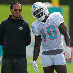 Miami Dolphins head coach Mike McDaniel talks with Miami Dolphins wide receiver Tyreek Hill (10) during practice at Baptist Health Training Complex.