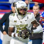 Nov 23, 2024; Kansas City, Missouri, USA; Colorado wide receiver Travis Hunter (12) catches the ball ahead of Kansas cornerback Cobee Bryant (2) for a touchdown during the 3rd quarter between the Kansas Jayhawks and the Colorado Buffaloes at GEHA Field at Arrowhead Stadium.
