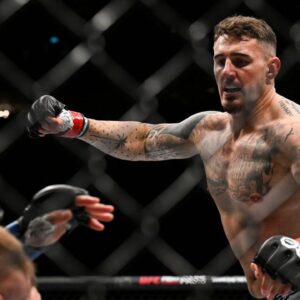 Tom Aspinall (red gloves) fights Marcin Tybura (blue gloves) during UFC Fight Night at O2 Arena.