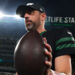 New York Jets quarterback Aaron Rodgers (8) walks off the field after the Jets win over the Houston Texans at MetLife Stadium.