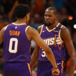 Phoenix Suns forward Kevin Durant (35) celebrates with forward Ryan Dunn (0) against the Dallas Mavericks in the second half of the home opener at Footprint Center.