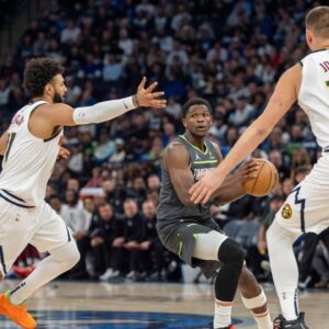 Minnesota Timberwolves guard Anthony Edwards (5) looks to pass to center Rudy Gobert (27)with Denver Nuggets guard Jamal Murray (27) and center Nikola Jokic (15) defending in the first quarter at Target Center.