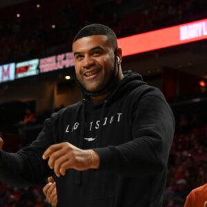 Shawne Merriman, former NFL and Maryland Terrapins linebacker, is recognized on the court for his charity Lights On Foundation's during the second half of the game against the George Washington Colonials at Xfinity Center.