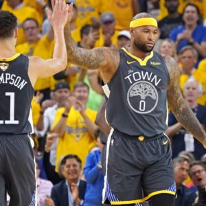 Golden State Warriors center DeMarcus Cousins (0) celebrates with Golden State Warriors guard Klay Thompson (11) during the first quarter against the Toronto Raptors in game six of the 2019 NBA Finals at Oracle Arena.