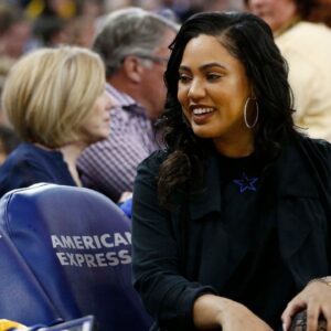 Ayesha Curry talks to a fan during a timeout between the Golden State Warriors and the Atlanta Hawks in the second quarter at Oracle Arena.