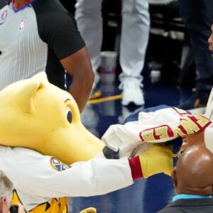 Denver Nuggets mascot Rocky shoves a signed jersey into the face of NBA former player Charles Barkley during halftime in game two of the 2023 NBA Finals between the Miami Heat and Denver Nuggets at Ball Arena.