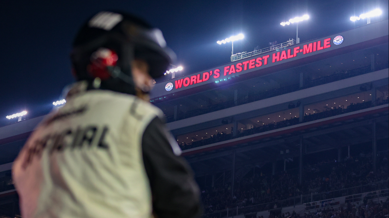 A NASCAR official watches during the Bass Pro Shops Night Race at Bristol Motor Speedway.