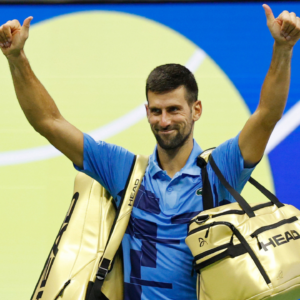 Novak Djokovic (SRB) waves to the crowd while leaving the court