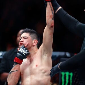 Brandon Moreno (red gloves) celebrates after defeating Amir Albazi (not pictured) in a flyweight bout during UFC Fight Night at Rogers Place.