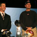 Baltimore Ravens head coach John Harbaugh (left) poses for a photo with San Francisco 49ers head coach Jim Harbaugh (right) during a press conference in preparation for Super Bowl XLVII at the New Orleans Convention Center.