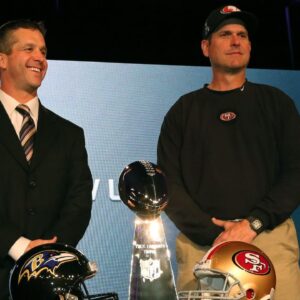 Baltimore Ravens head coach John Harbaugh (left) poses for a photo with San Francisco 49ers head coach Jim Harbaugh (right) during a press conference in preparation for Super Bowl XLVII at the New Orleans Convention Center.