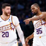 Phoenix Suns forward Kevin Durant (35) and Phoenix Suns guard Devin Booker (1) and Phoenix Suns center Jusuf Nurkic (20) talk during the third quarter against the Dallas Mavericks at American Airlines Center.
