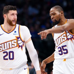 Phoenix Suns forward Kevin Durant (35) and Phoenix Suns guard Devin Booker (1) and Phoenix Suns center Jusuf Nurkic (20) talk during the third quarter against the Dallas Mavericks at American Airlines Center.
