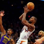 Phoenix Suns forward Kevin Durant (35) shoots the ball against Los Angeles Lakers forward Rui Hachimura (28) during the second half at Footprint Center.